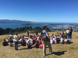 Students and adults at the top of Mt. Kaukau. Wellington Harbor in the distance.